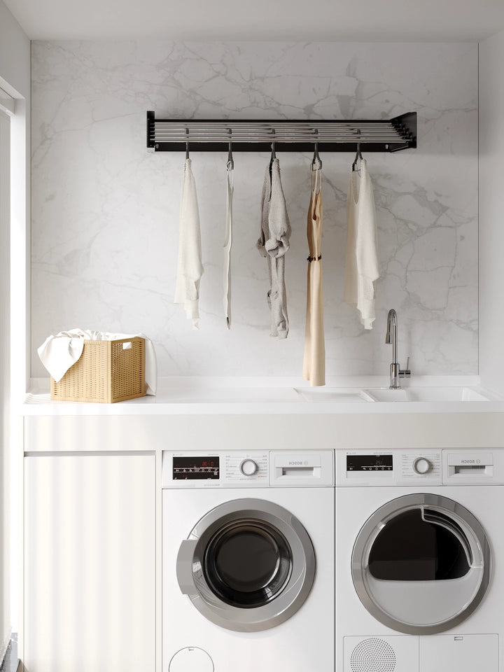 EaseRack Retractable wall-mounted drying rack installed in a balcony laundry area with washing machine and sink.