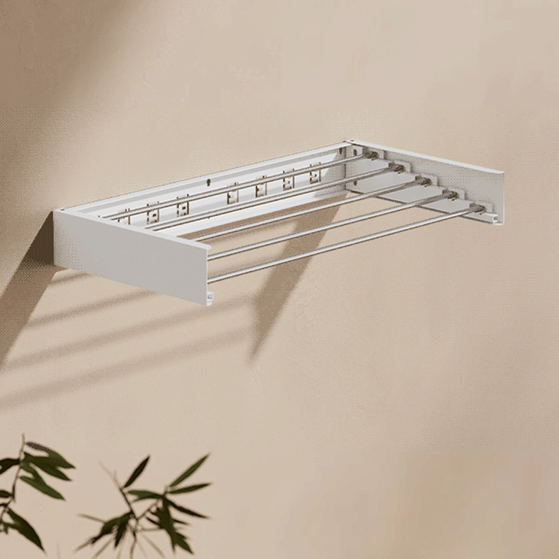 Close-up of EaseRack wall-mounted foldable clothes hanger in compact living space