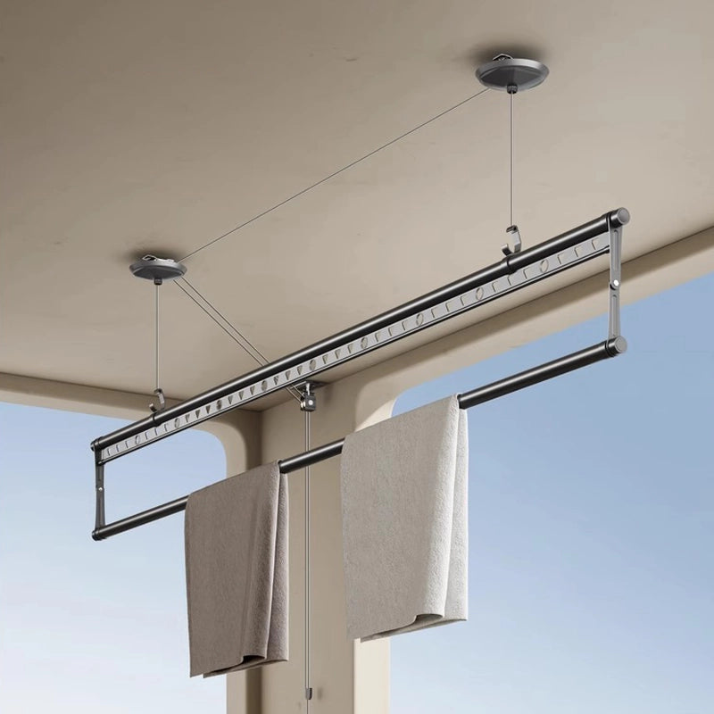 Hand crank ceiling drying rack easily lifting large laundry loads in a modern balcony.