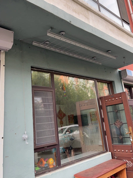 Side view of the hand winch ceiling mounted clothes drying rack, space-saving and easy to operate.