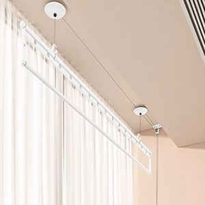 Ceiling mounted clothes drying rack installed in narrow curtain gap for small spaces.