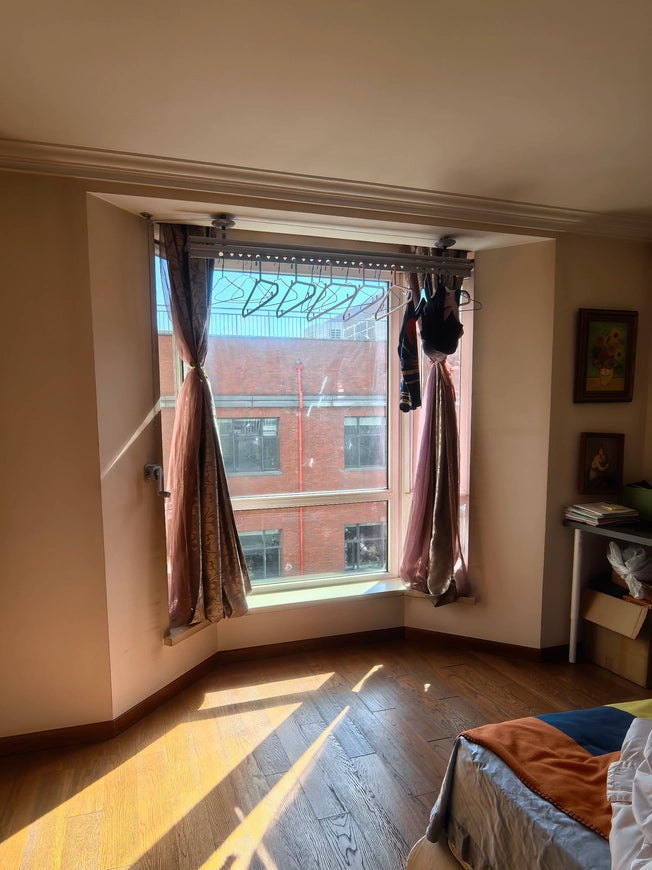 Manual Ceiling drying rack mounted inside bay window with natural sunlight