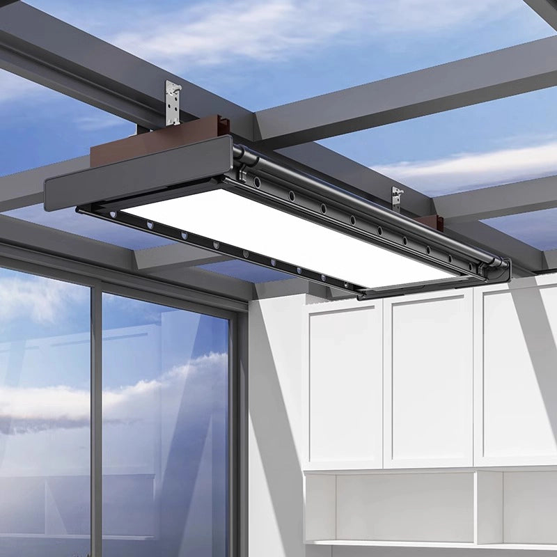 Electric ceiling clothes drying rack installed on custom brackets in a sunroom.