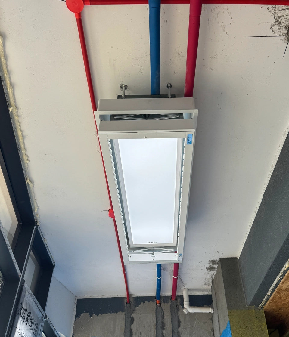 M20 electric drying rack mounted around exposed water pipes on ceiling