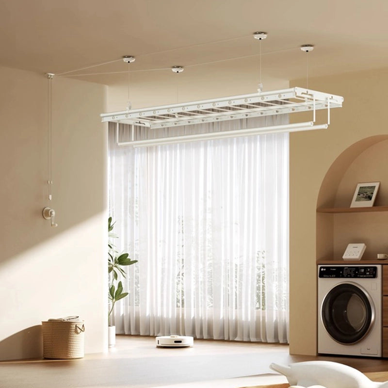 Milk-white ceiling-mounted manual clothes drying rack installed in a cozy laundry area with sunlight streaming through sheer curtains, ideal for drying clothes and bedding indoors.