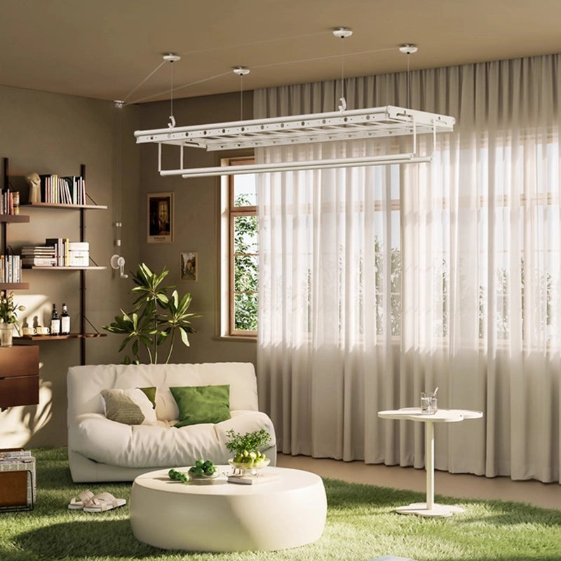 Milk-white ceiling-mounted hand-crank clothes drying rack in a cozy living room with green decor and sunlight streaming through sheer curtains.