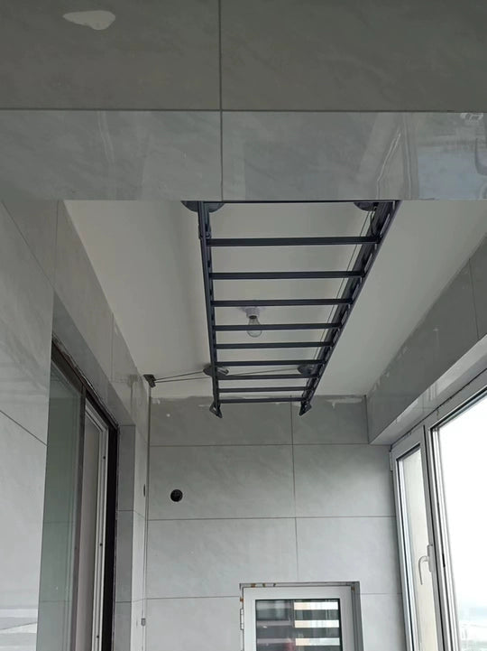 Square Tube Space-saving ceiling clothes drying rack installed on tiled indoor balcony
