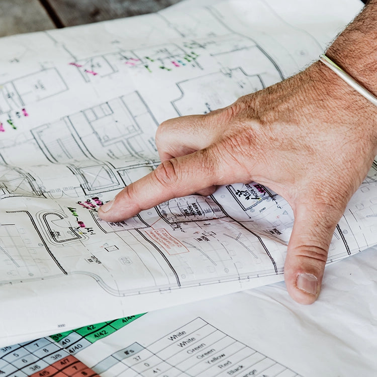 Architect reviewing interior design blueprints for custom integration
