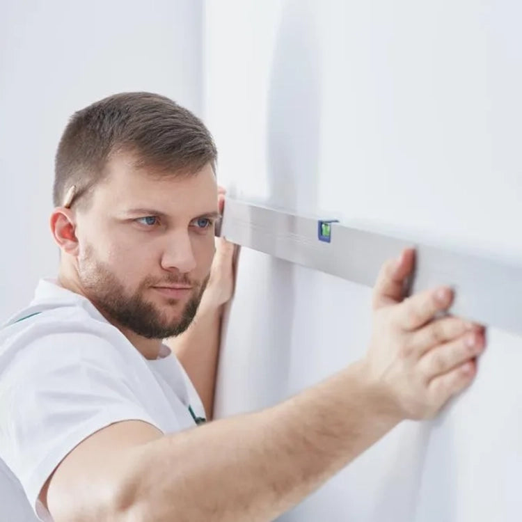 Professional installer leveling surface for clothes rack installation