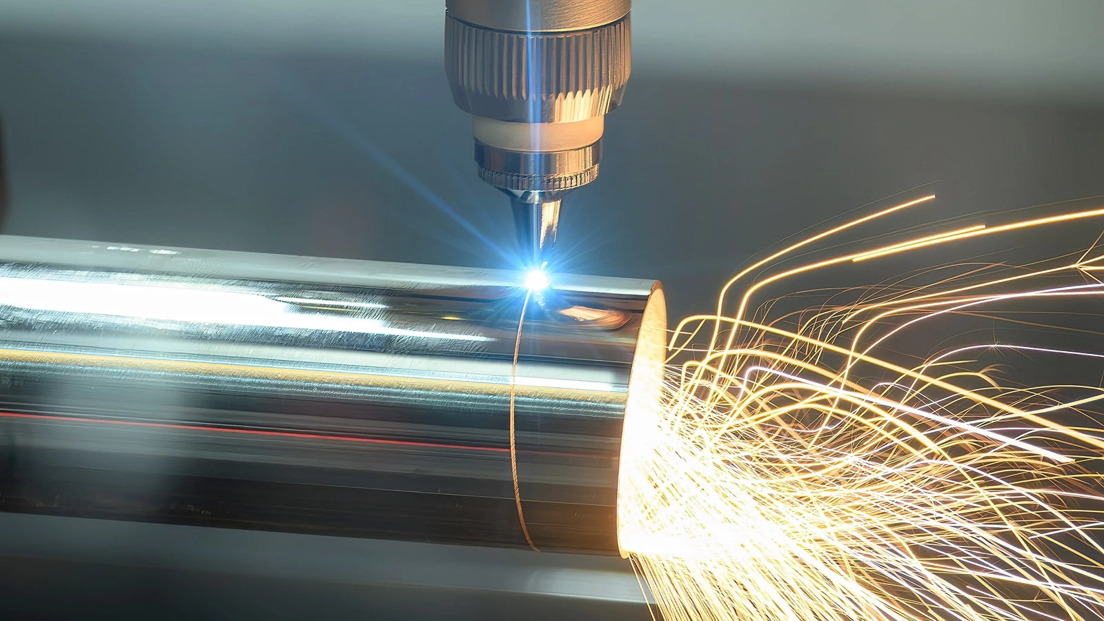 Laser cutting machine processing metal with bright sparks, showcasing precision manufacturing and efficient production.