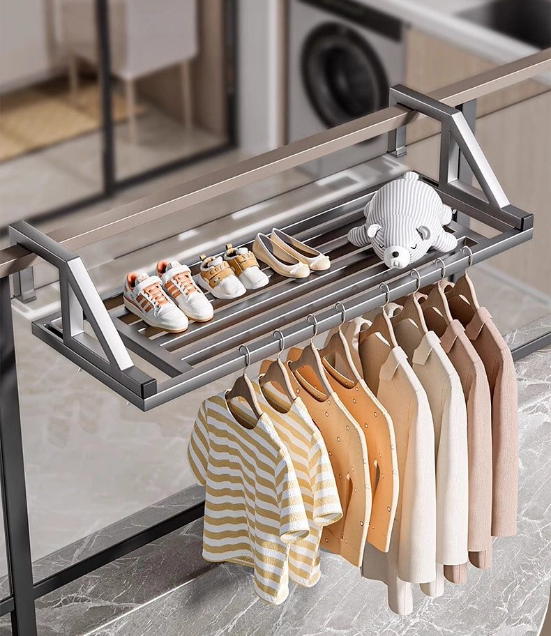Durable metal clothes drying rack mounted on balcony railing, holding shirts, towels, and shoes for efficient outdoor drying.