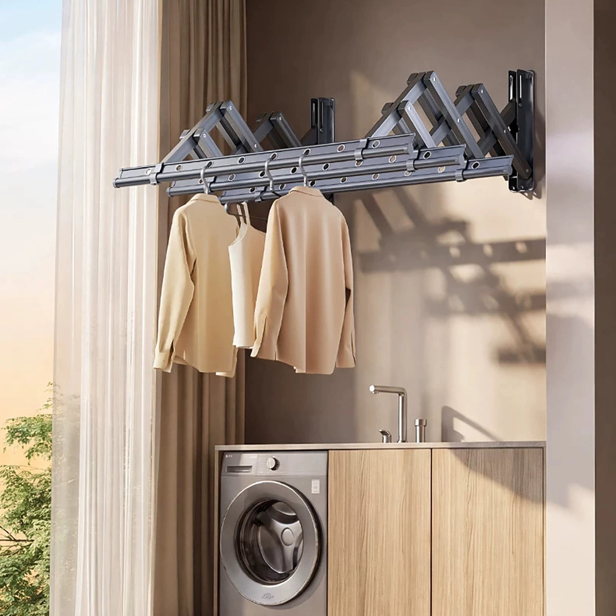 EaseRack wall-mounted retractable drying rack with clothes above a washing machine in an indoor laundry room.