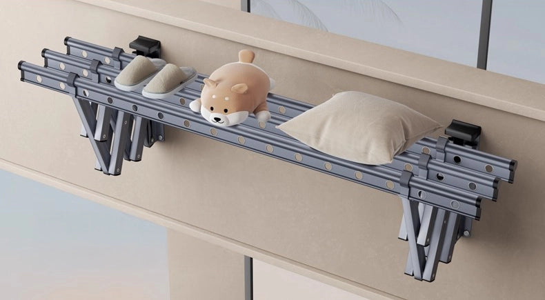 Folded wall-mounted retractable drying rack holding pillows and items to show strong load capacity.
