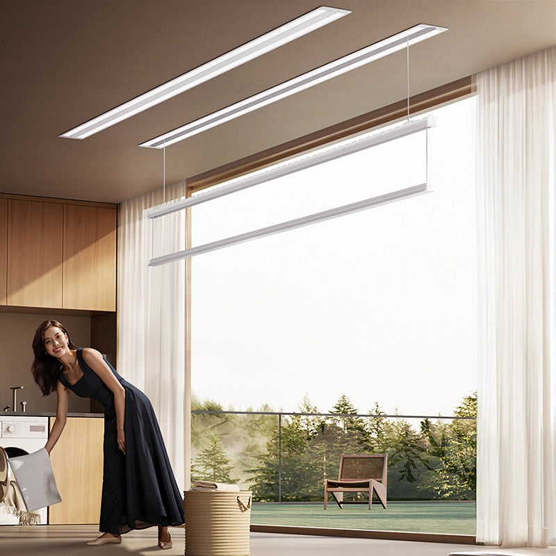 Woman doing laundry in a bright, modern home with an Easerack ceiling-mounted clothes drying rack, combining elegance, sunlight, and effortless living.