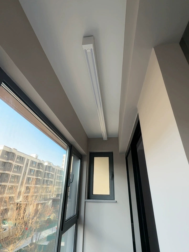 Balcony ceiling mounted clothes drying rack designed for compact apartments, combining practical laundry use with a clean look.