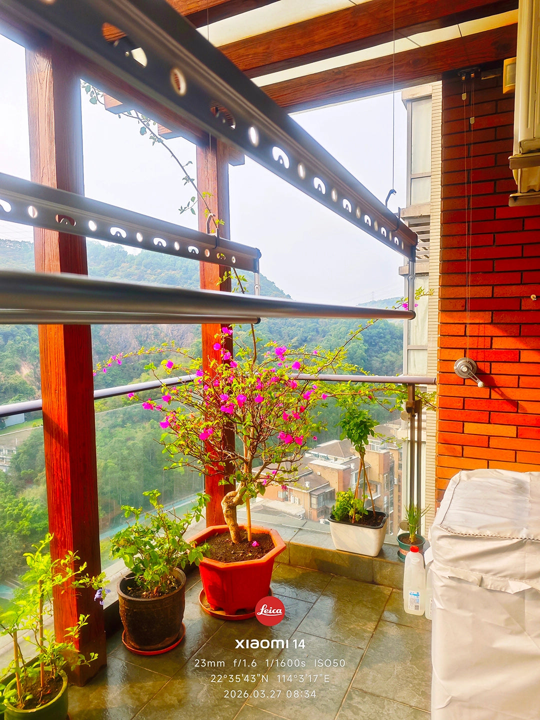 Real customer installation of a Square-Rod ceiling clothes airer on a covered balcony with a wall-mounted manual winch