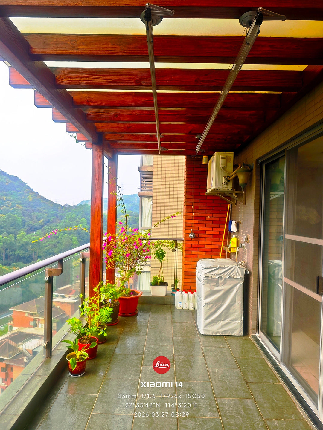 Square-Rod ceiling clothes airer raised near the ceiling in a covered residential balcony