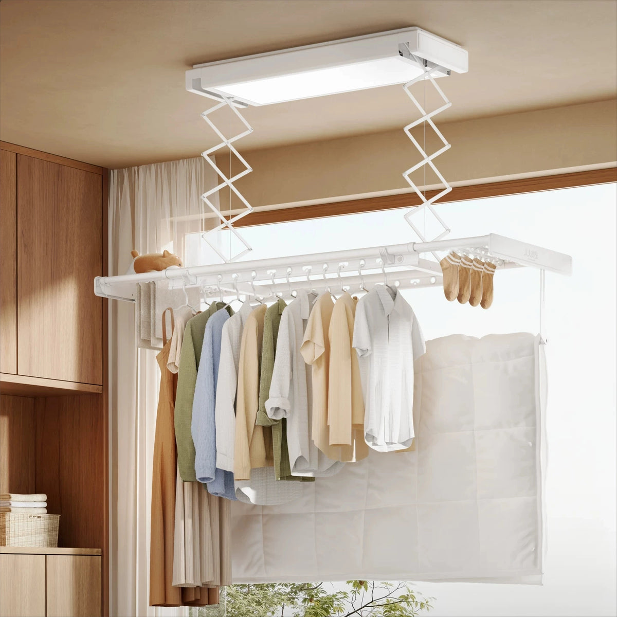 EaseRack V6 electric ceiling clothes airer in use with clothes, bedding and small laundry items